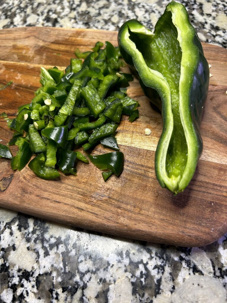 Half of a sliced poblano pepper and half of a diced poblano pepper