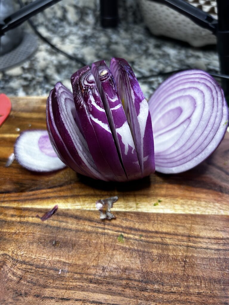 Sliced red onion of cutting board