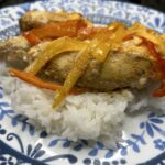 Cheesy pepper chicken over a bed of rice served on a palte