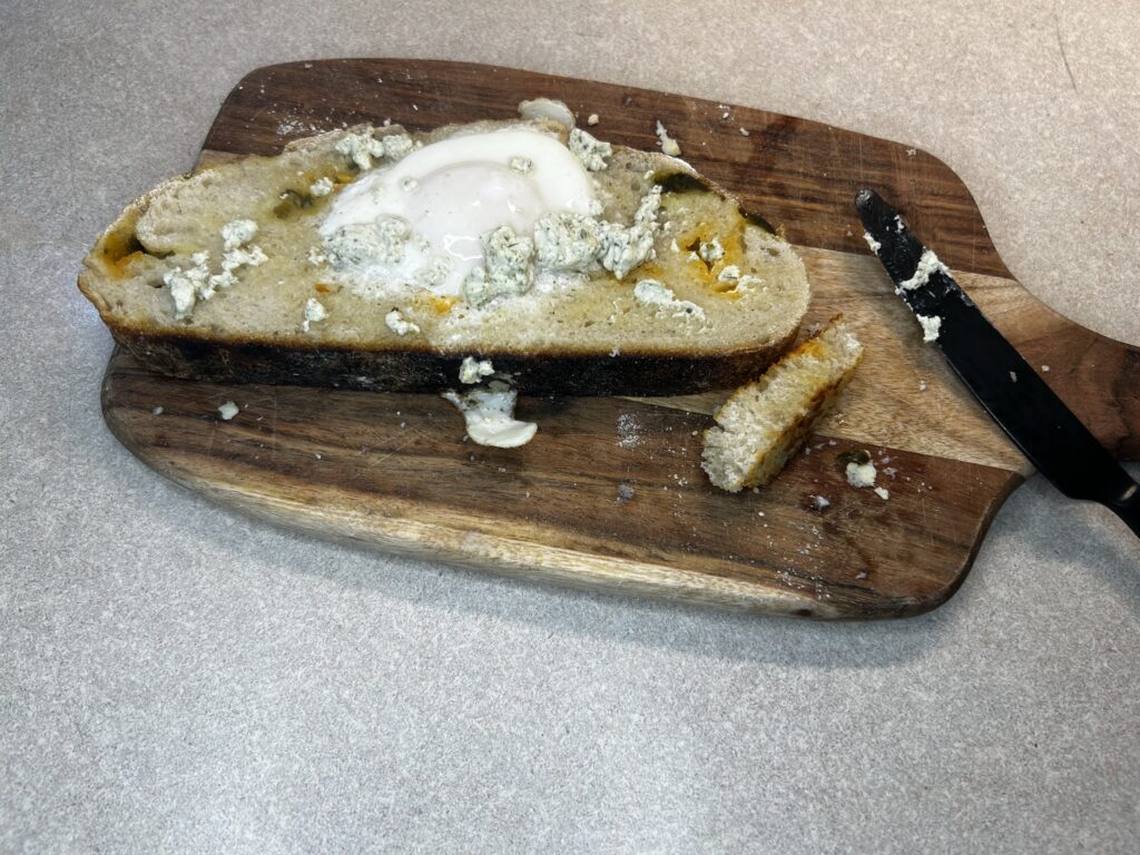 homemade sourdough egg in a hole on cutting board