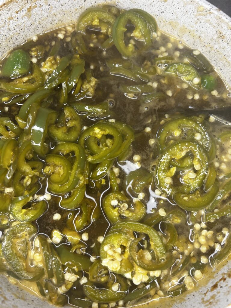 jalapenos in pot with sauce