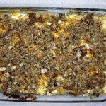 Pulled pork mac and cheese topped with breadcrumbs in baking dish